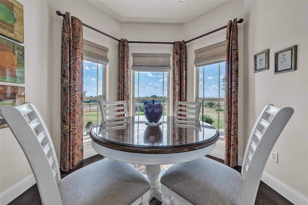 Bay window with multiple vertical windows, recessed lighting, and dark wood-finish flooring