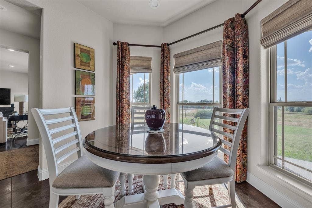 Wood-finish flooring, white trim, recessed lighting, and multiple windows