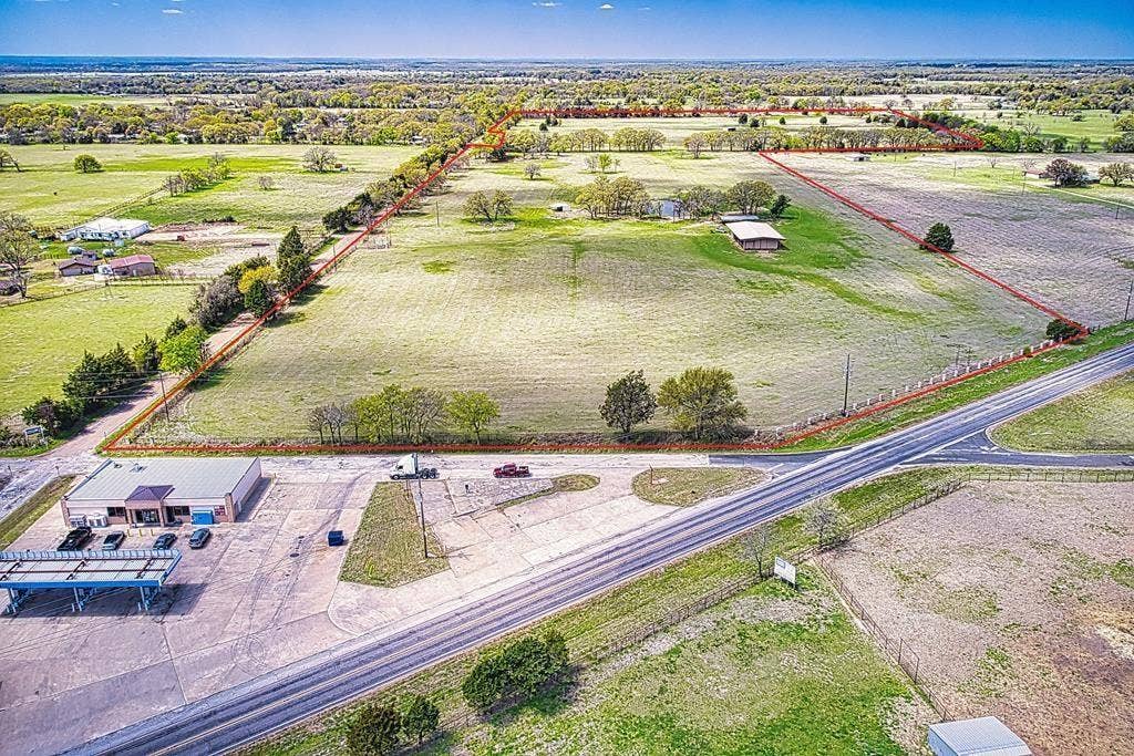 00 Tx-274 Highway, Kemp, TX 75143 Expansive acreage with a single-story commercial building, mature trees, and a paved road frontage