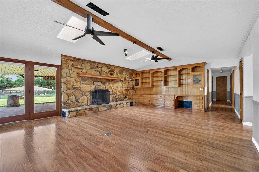 106 Snyder Ranch Road, Trinidad, TX 75163 Living room with massive stone wood-burning fireplace and lots of built-ins