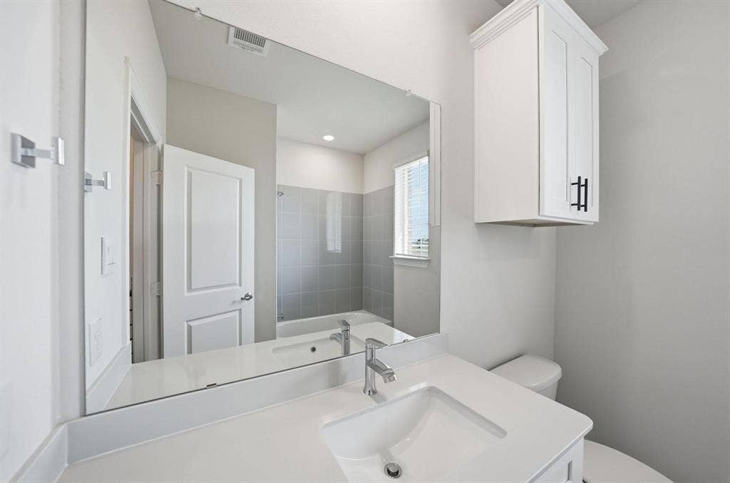 4532 Community Court, Plano, TX 75024 Integrated vanity with an undermount sink, a chrome faucet, and a large wall-mounted mirror