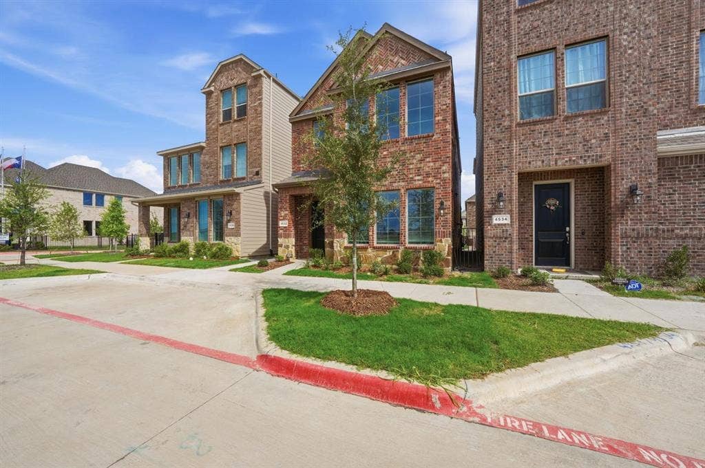 4532 Community Court, Plano, TX 75024 Brick exterior with contrasting siding accents, multiple windows, and a covered entry