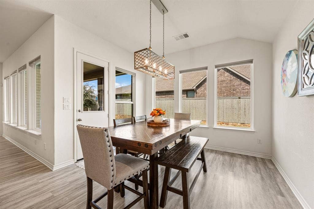 2900 Peekaboo Lane, Northlake, TX 76247 Wonderful kitchen Nook featuring high ceilings, LTV flooring, an updated chandelier, and surrounded by beautiful windows letting in natural light!