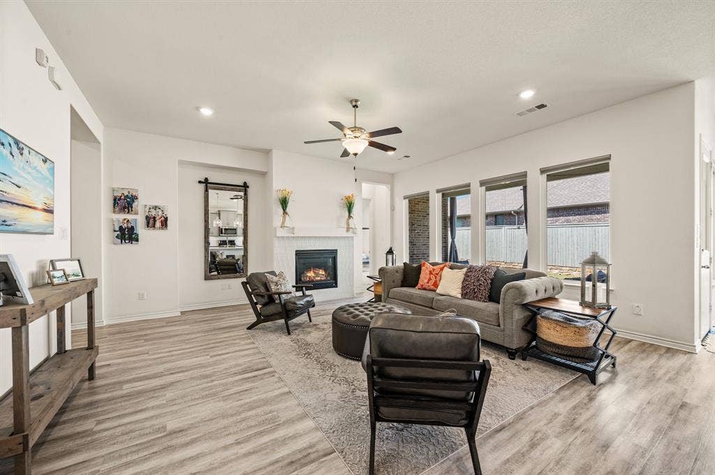 2900 Peekaboo Lane, Northlake, TX 76247 Open and bright living space with a beautiful fireplace with gorgeous tile around it and so much space to entertain your family & friends.