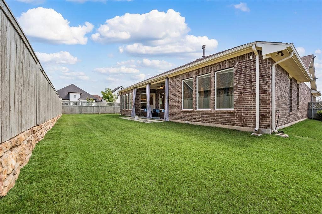 2900 Peekaboo Lane, Northlake, TX 76247 Expansive and beautiful green lawn with a wood fence and so much room for pets and your family and friends...Maybe a pool?