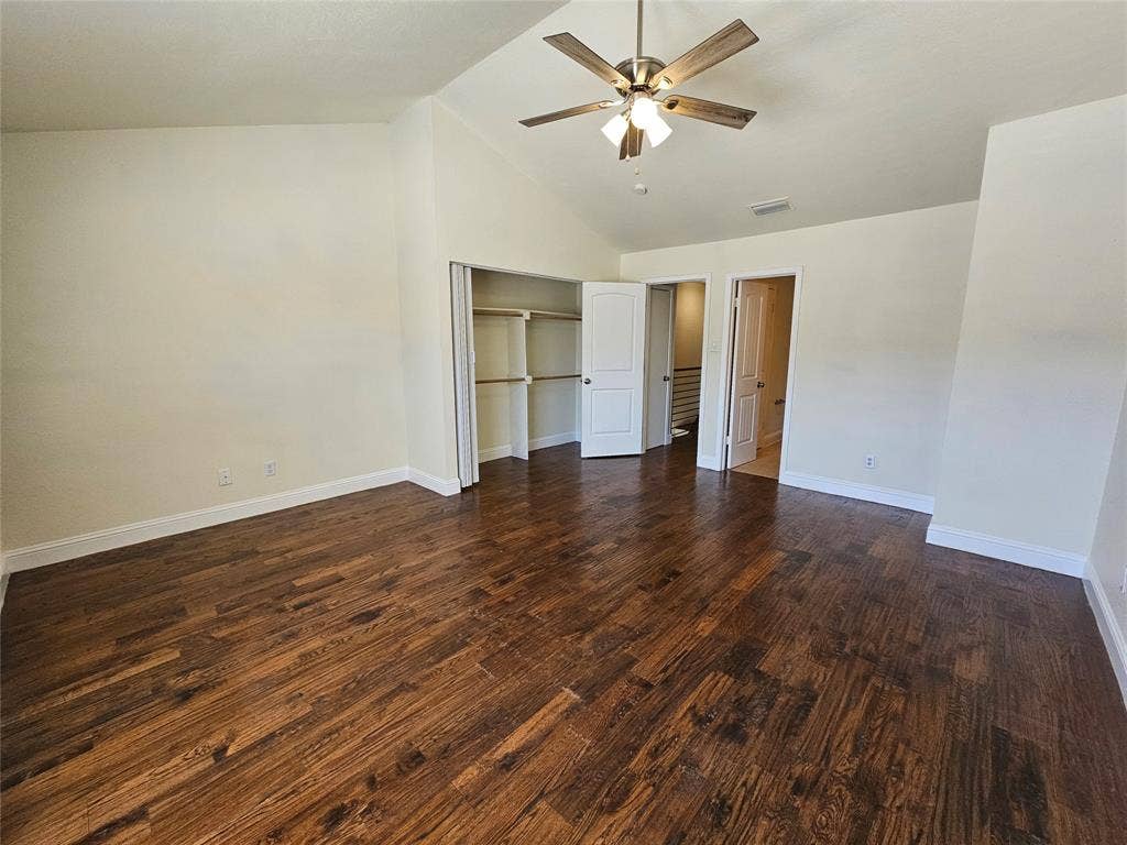 216 Samuel Boulevard, #j3, Coppell, TX 75019 Vaulted ceiling with a ceiling fan, wood-finish flooring, and built-in closet shelving