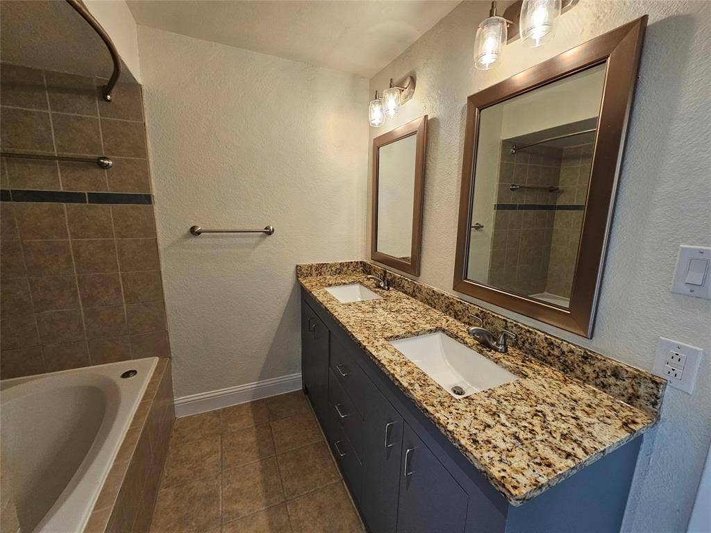 216 Samuel Boulevard, #j3, Coppell, TX 75019 Dual vanity with undermount sinks, granite countertop, and built-in cabinetry