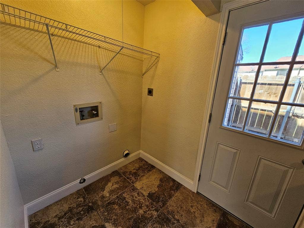 216 Samuel Boulevard, #j3, Coppell, TX 75019 Utility space featuring a glass-paned door, wire shelving, and durable floor tiling