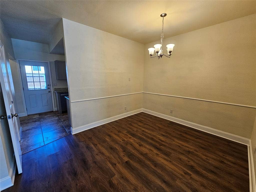 216 Samuel Boulevard, #j3, Coppell, TX 75019 Wood-finish flooring, crown molding, and a four-light chandelier