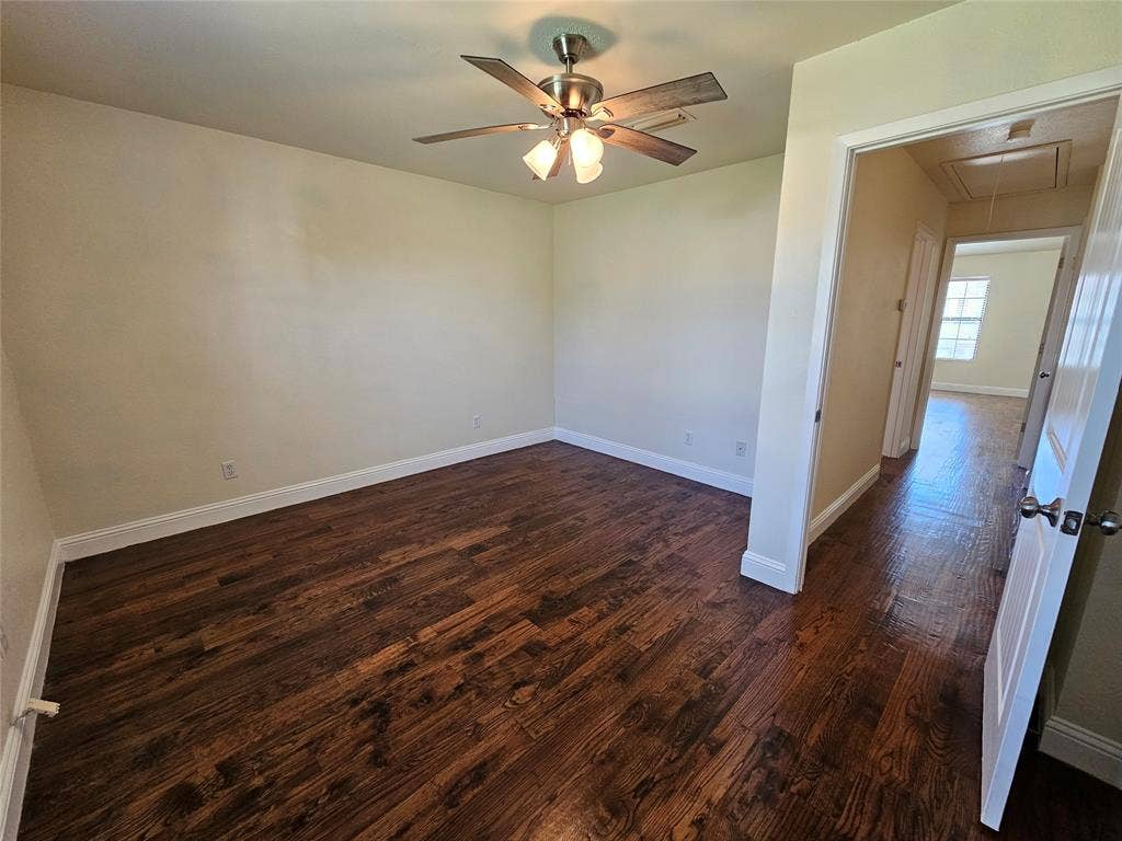 216 Samuel Boulevard, #j3, Coppell, TX 75019 Wood-finish flooring, ceiling fan with integrated lighting, neutral wall paint, white trim, and a white interior door