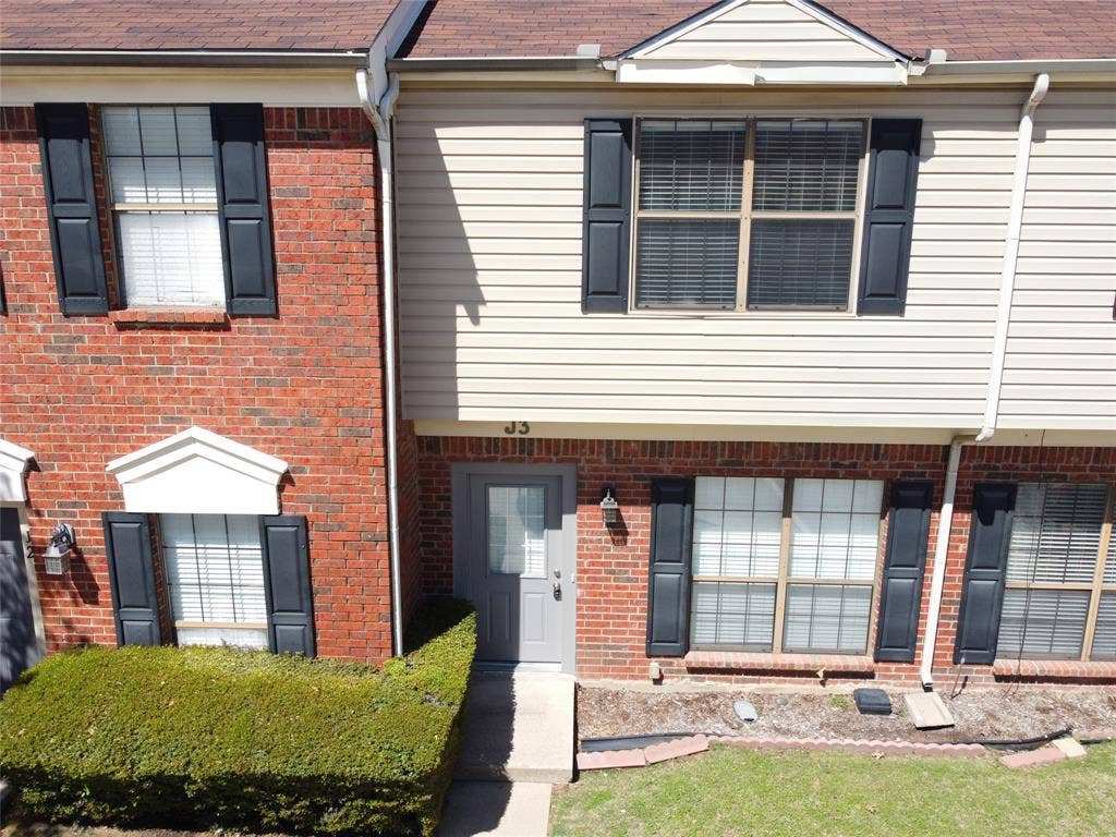 216 Samuel Boulevard, #j3, Coppell, TX 75019 Brick and siding exterior with dark shutters, featuring a prominent front entry door