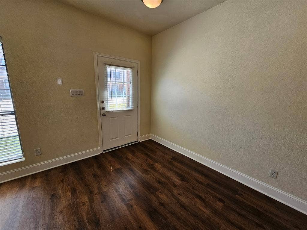 216 Samuel Boulevard, #j3, Coppell, TX 75019 Wood-finish flooring, white trim, and a white paneled door with a privacy glass insert