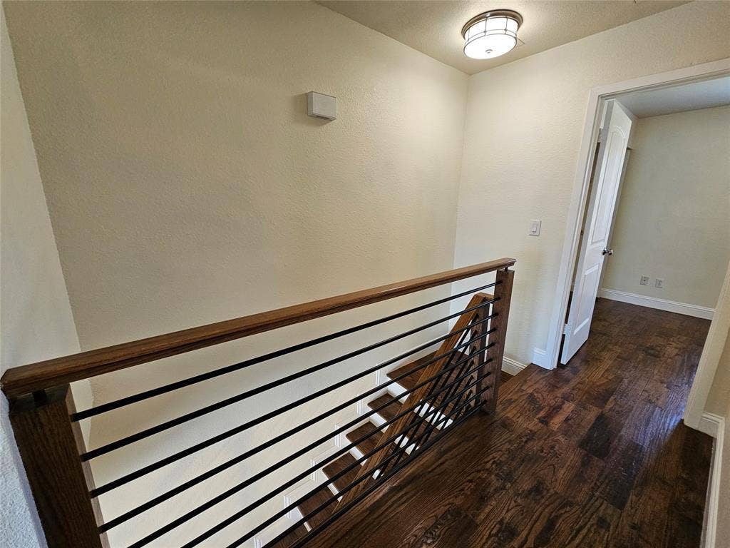 216 Samuel Boulevard, #j3, Coppell, TX 75019 Hardwood flooring extending throughout, contemporary metal and wood railing, and a flush-mount ceiling light fixture