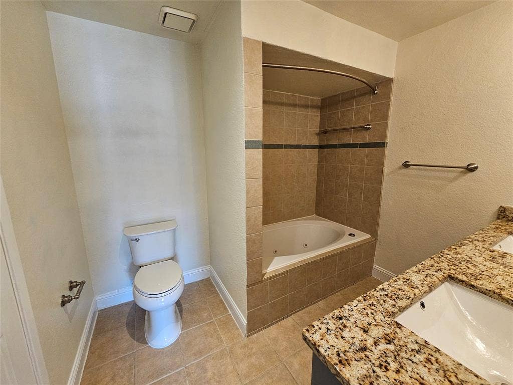 216 Samuel Boulevard, #j3, Coppell, TX 75019 Dual vanity with granite countertops, undermount sinks, and an integrated jetted tub