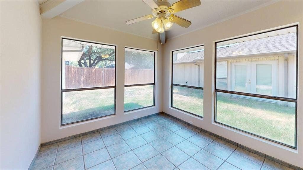 3717 Atrium Drive, Plano, TX 75075 Tile flooring, multiple windows, exposed beam ceiling, and a ceiling fan with integrated lighting