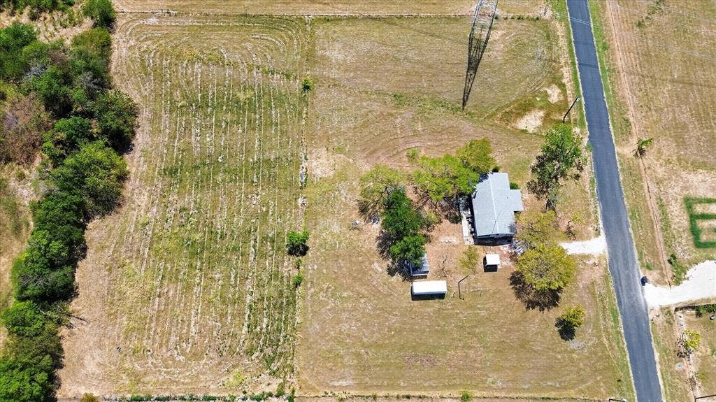 11929 County Road 950, Rockwall, TX 75087 Single-story dwelling with a gray roof and surrounding mature trees