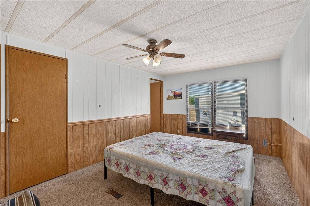 11929 County Road 950, Rockwall, TX 75087 Carpeted flooring with wood-finish paneling and white paneled walls