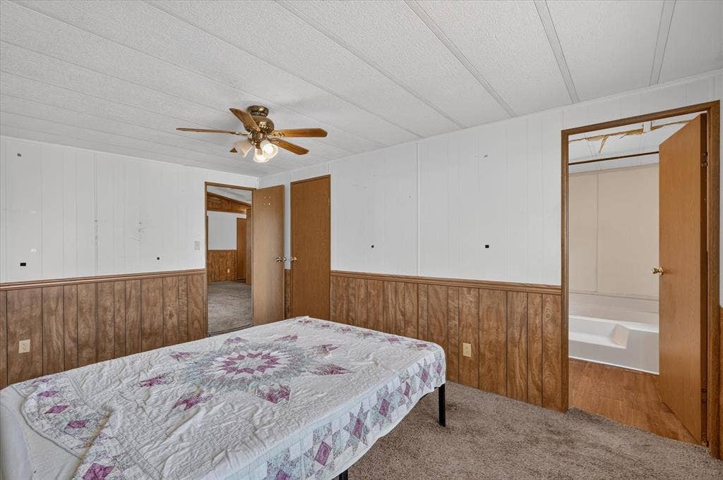 11929-1 County Road 950, Rockwall, TX 75087 Carpeted flooring, wood-panel wainscoting, and a ceiling fan