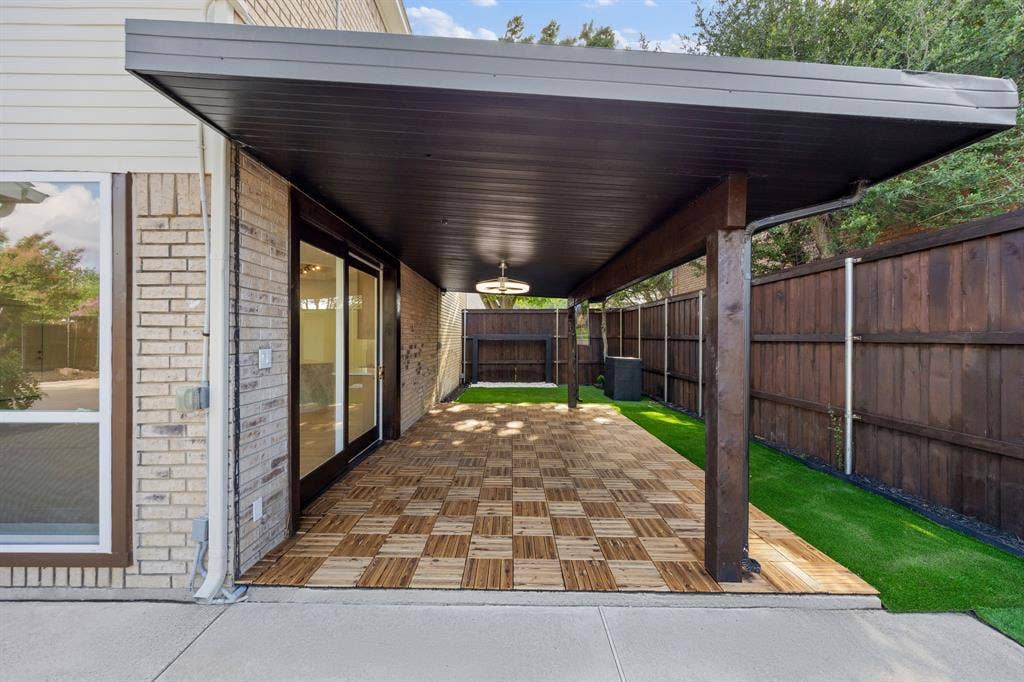7504 Hughes Drive, Plano, TX 75024 Expansive covered patio featuring a checkered wood-finish floor and overhead lighting