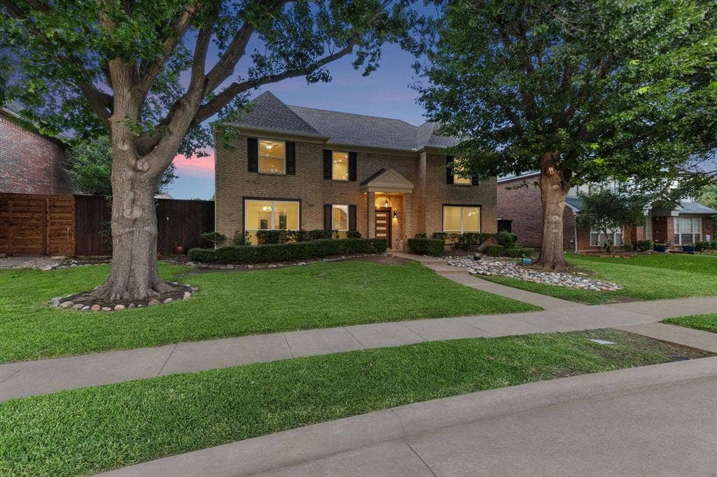 7504 Hughes Drive, Plano, TX 75024 Traditional brick exterior with a prominent gabled roofline