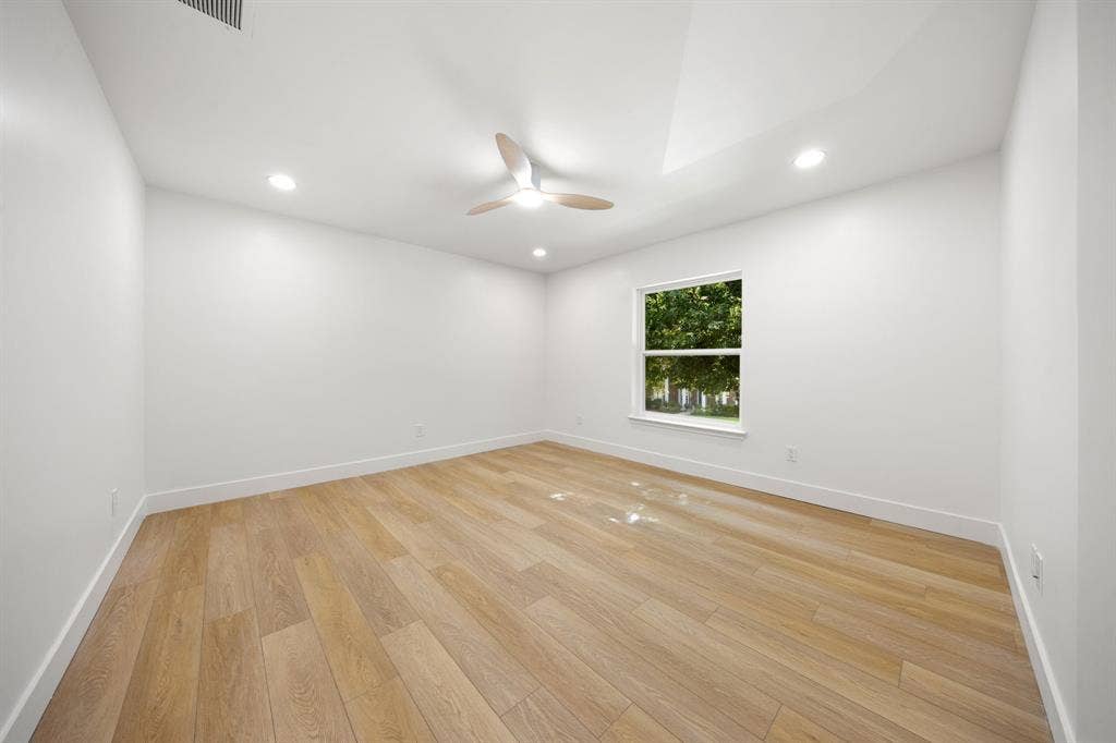 7504 Hughes Drive, Plano, TX 75024 Bright room featuring wood-finish flooring, a contemporary ceiling fan, recessed lighting, a single window, and a vaulted ceiling