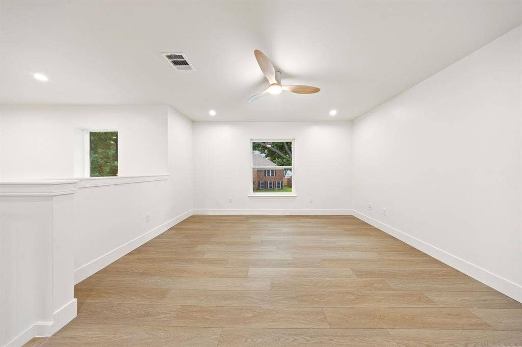 7504 Hughes Drive, Plano, TX 75024 Spacious room featuring wood-finish flooring, recessed lighting, and a contemporary ceiling fan