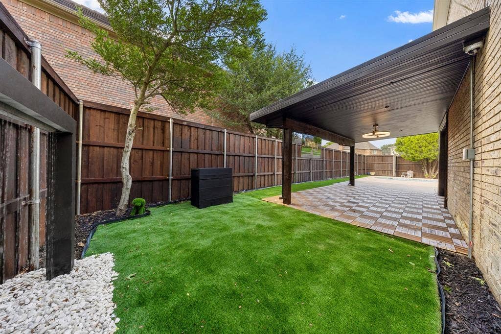7504 Hughes Drive, Plano, TX 75024 Covered patio featuring patterned tile flooring, wood support columns, and an overhead light fixture