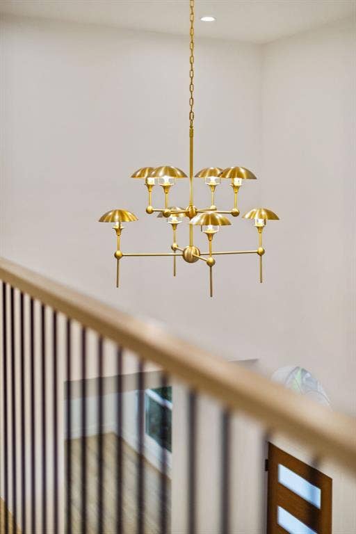 7504 Hughes Drive, Plano, TX 75024 Contemporary brass chandelier with multiple lights, suspended from a high ceiling