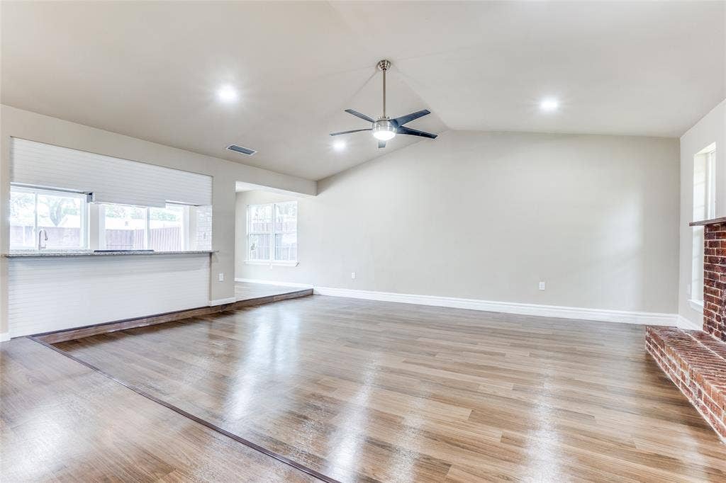 1904 Richland Drive, Richardson, TX 75081 Vaulted ceiling, wood-finish flooring, recessed lighting, ceiling fan, and a brick fireplace