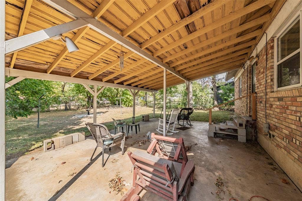 1313 Killian Drive, Arlington, TX 76013 Covered patio with a wood-plank ceiling, concrete flooring, and brick exterior wall
