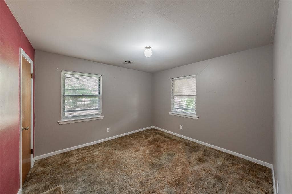 1313 Killian Drive, Arlington, TX 76013 Room featuring two windows, neutral-toned walls, and a ceiling-mounted light fixture