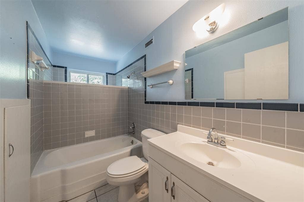 1313 Killian Drive, Arlington, TX 76013 Bathroom featuring a white vanity with integrated sink, chrome faucet, and expansive mirror