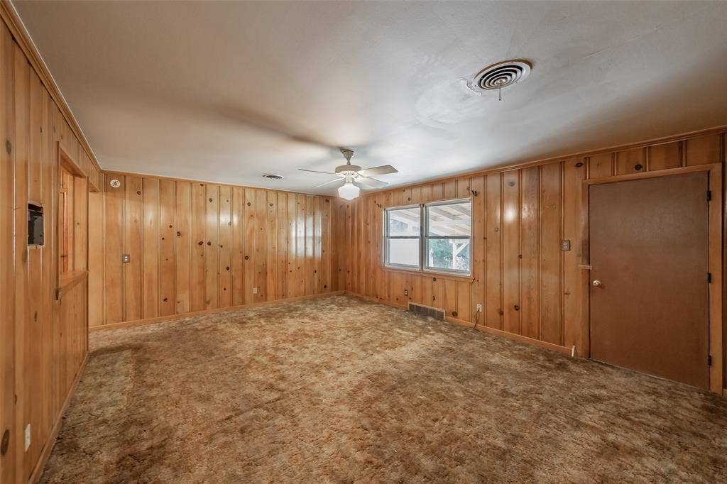 1313 Killian Drive, Arlington, TX 76013 Wood paneling accents walls, white ceiling with ceiling fan, and carpeted flooring