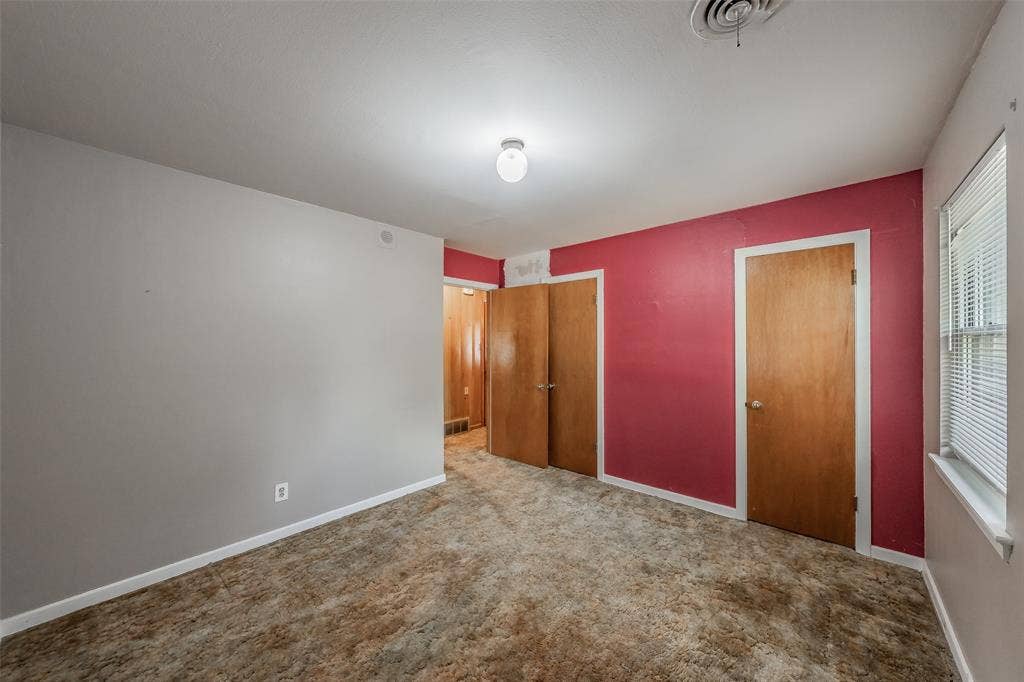 1313 Killian Drive, Arlington, TX 76013 Wall-to-wall carpeting with multiple wood doors, a single window, and a ceiling-mounted light fixture