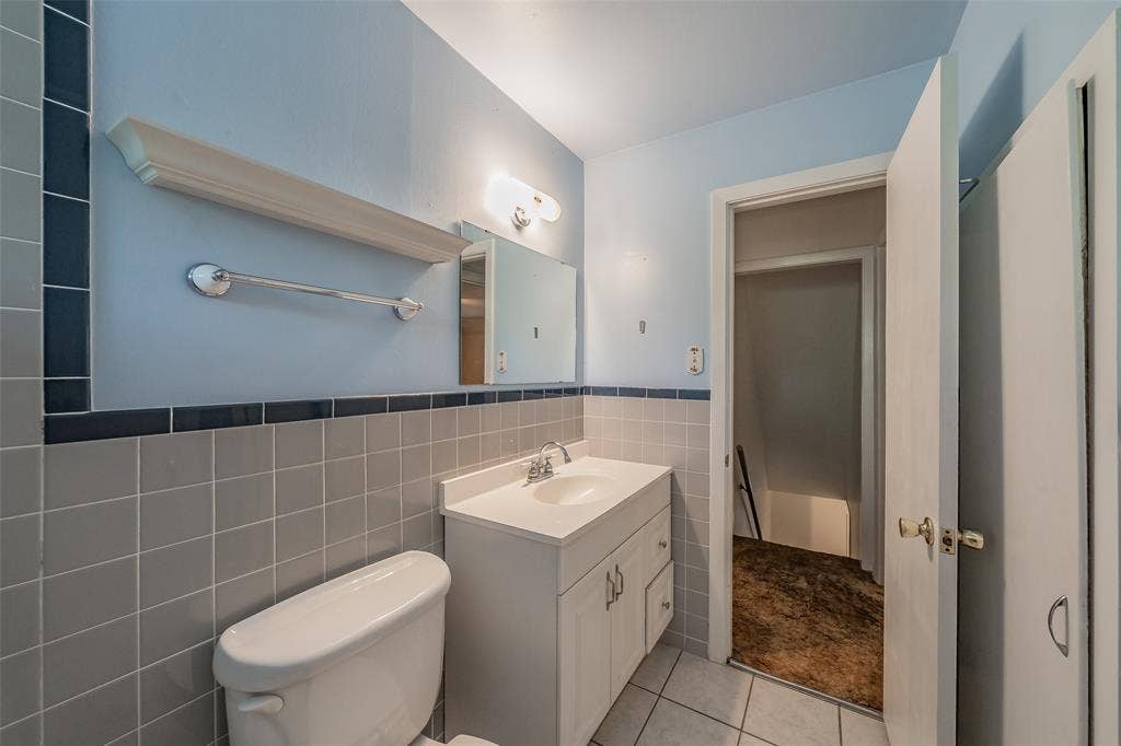 1313 Killian Drive, Arlington, TX 76013 White vanity with an integrated sink, polished chrome faucet, and overhead lighting