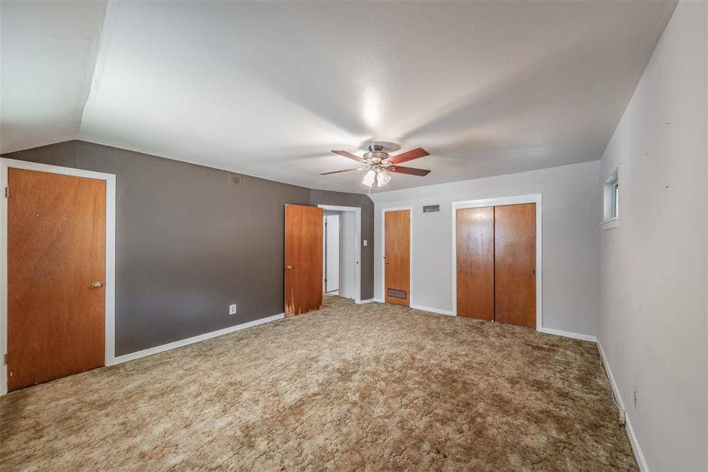 1313 Killian Drive, Arlington, TX 76013 Spacious room featuring a ceiling fan, multiple wood-finish doors, and a window