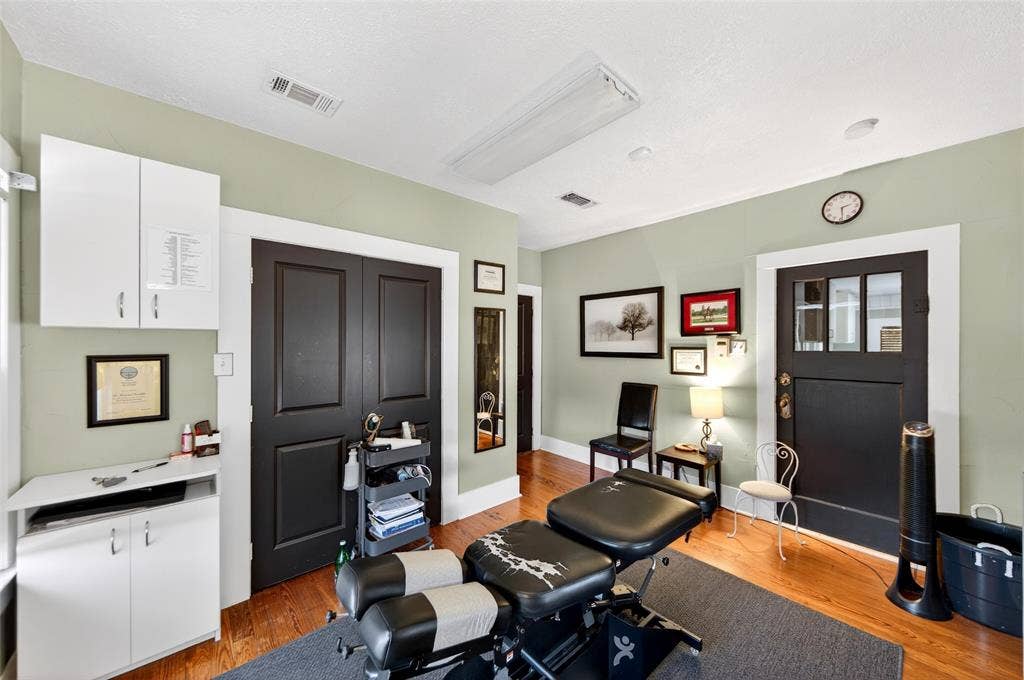 508 W Main Street, Allen, TX 75013 Hardwood-finish flooring, built-in white cabinetry, black paneled doors, and a decorative transom window