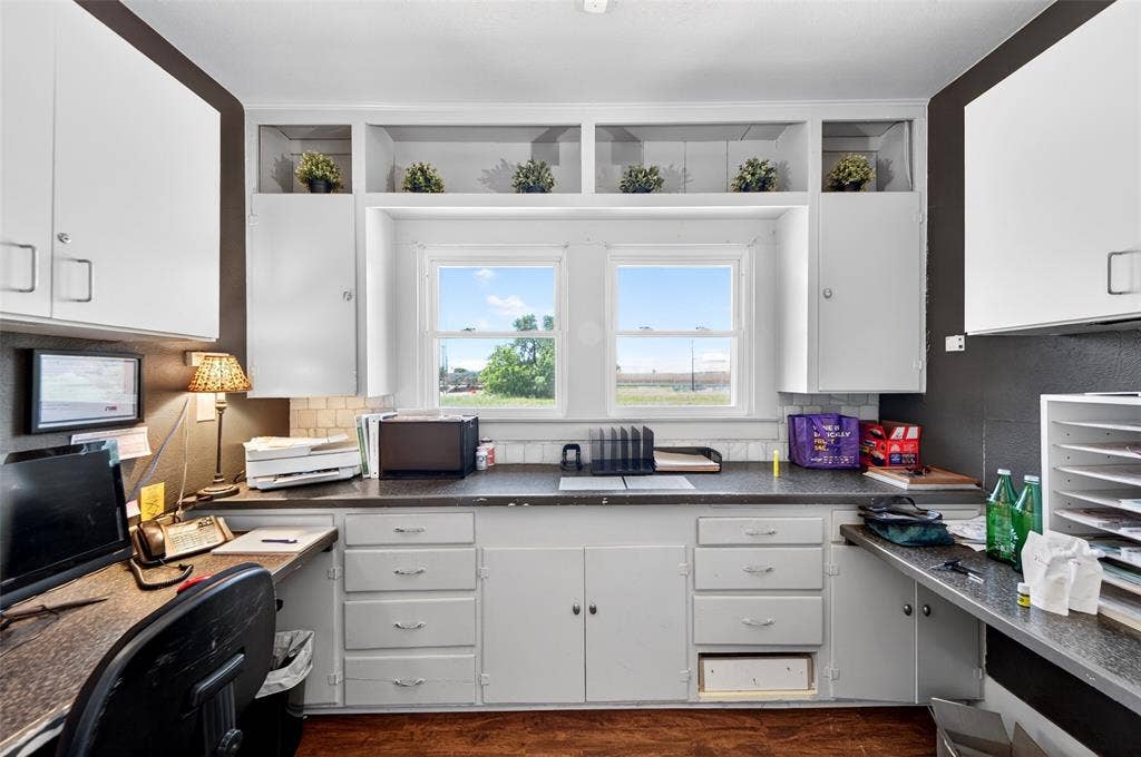 508 W Main Street, Allen, TX 75013 Built-in white cabinetry and shelving, dual windows providing natural light, extensive countertop space, and wood-finish flooring
