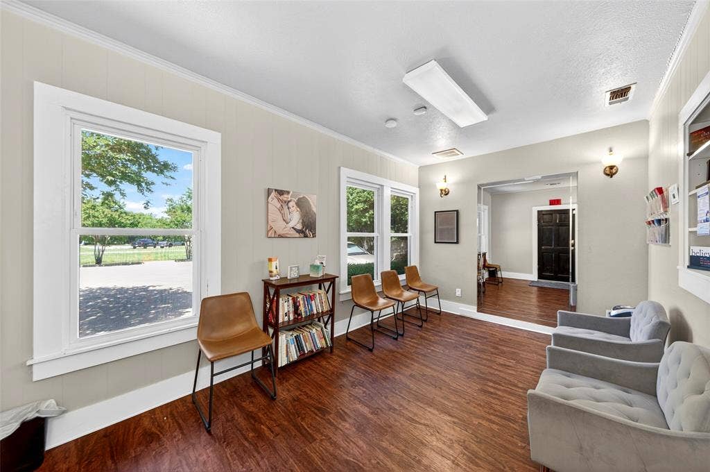 508 W Main Street, Allen, TX 75013 Wood-finish flooring, white trim, and light-toned wall paneling define this interior space, illuminated by multiple windows