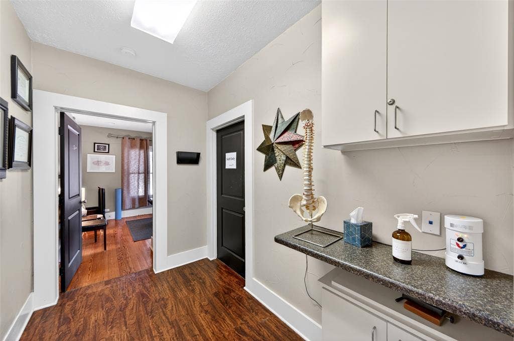 508 W Main Street, Allen, TX 75013 Wood-finish flooring, white trim, recessed lighting, built-in upper cabinetry, and a countertop with lower cabinetry
