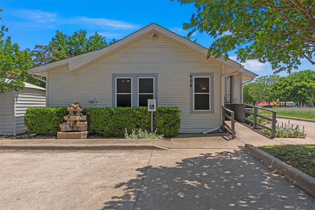 508 W Main Street, Allen, TX 75013 Exterior featuring siding, multiple windows, a tiered fountain, and a ramp access