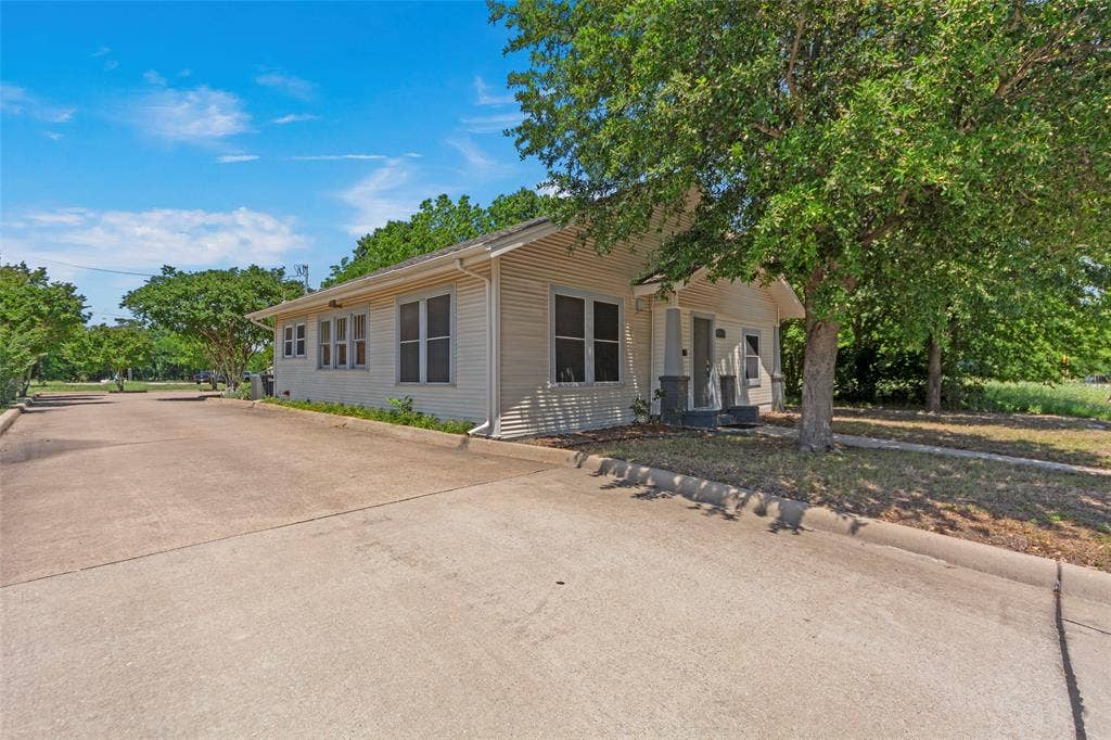 508 W Main Street, Allen, TX 75013 Siding exterior with multiple windows, covered porch entry, mature tree, and concrete driveway