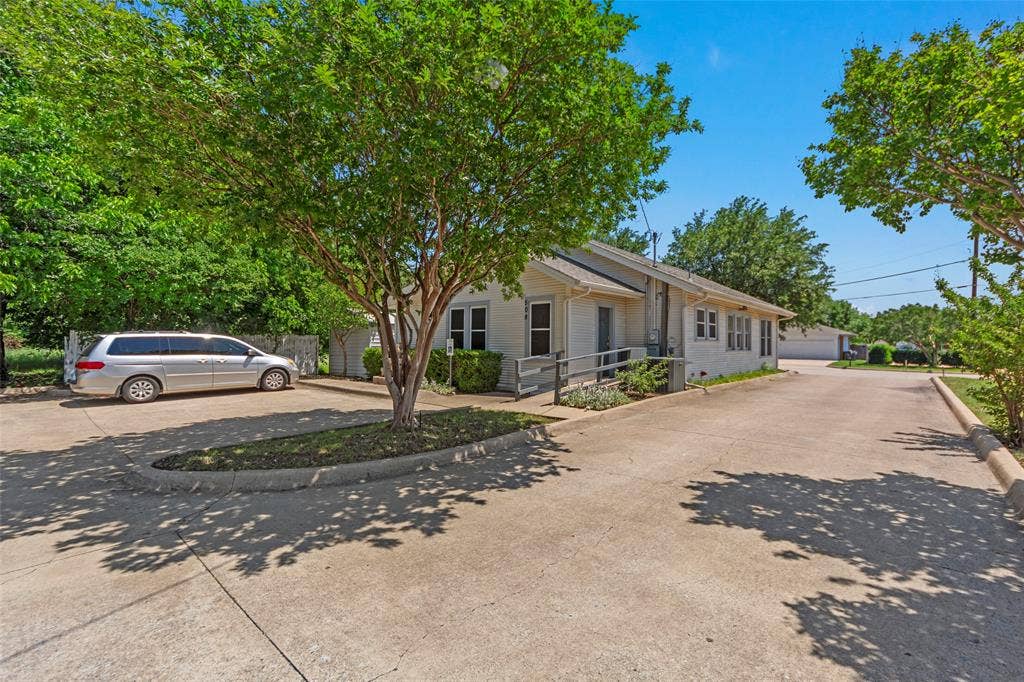 508 W Main Street, Allen, TX 75013 Expansive concrete parking area with mature trees and landscaping