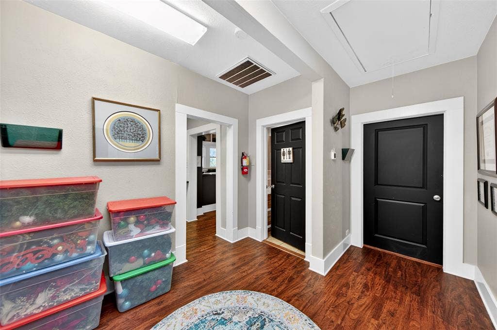 508 W Main Street, Allen, TX 75013 Wood-finish flooring with white trim and dark panel doors