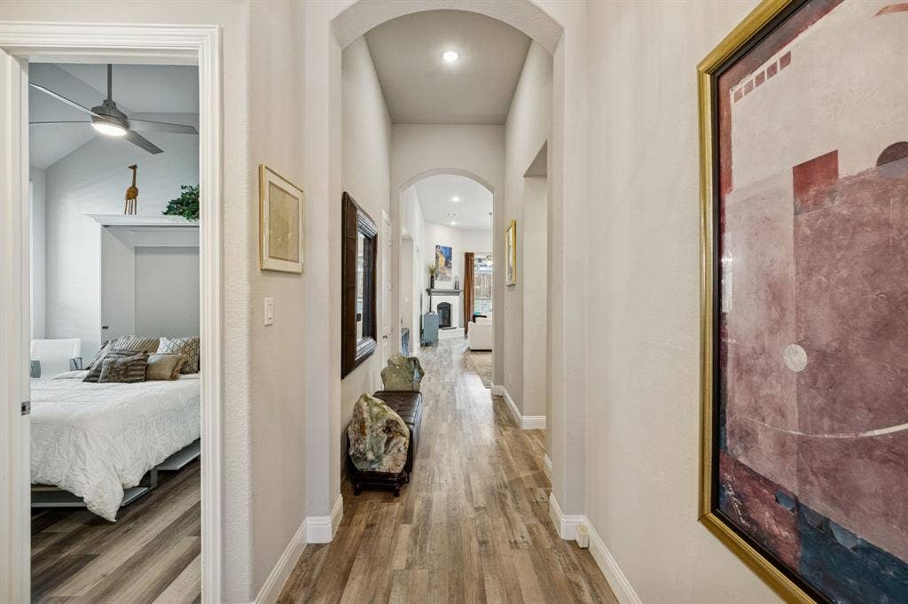 hallway leading to living area with bedroom visible on the left