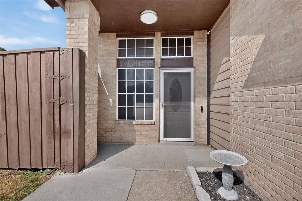 6747 Silver Sage Drive, Fort Worth, TX 76137 Brick exterior with a covered entry