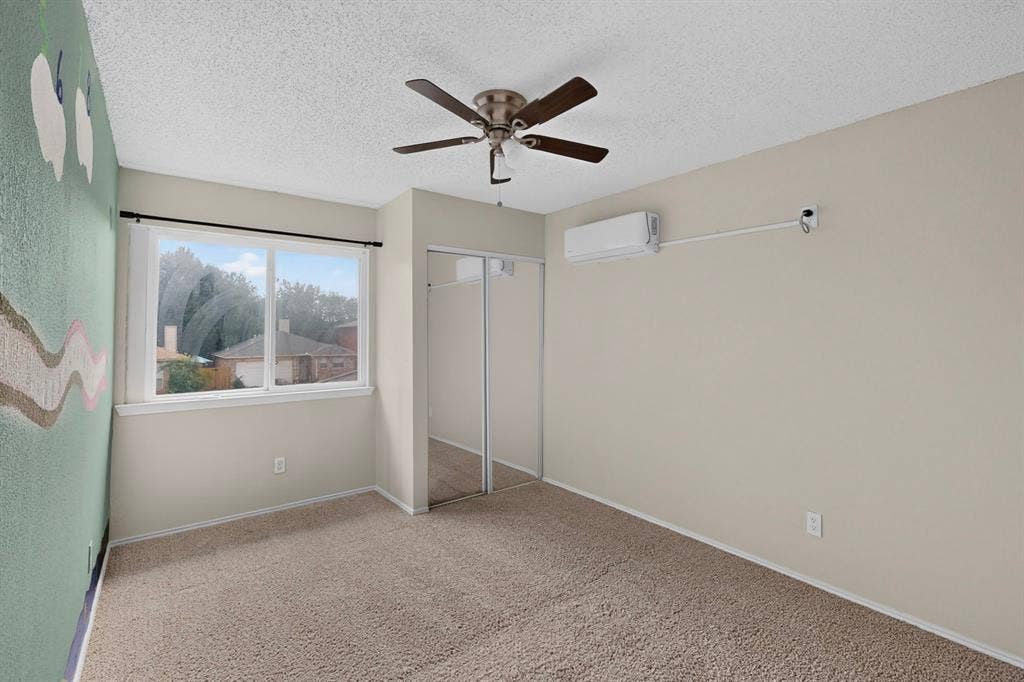 6747 Silver Sage Drive, Fort Worth, TX 76137 Wall-to-wall carpeting, ceiling fan, dual sliding mirrored closet doors, and window unit