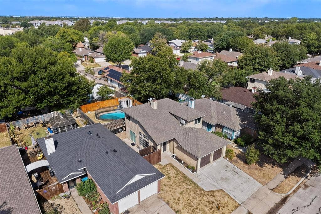 6747 Silver Sage Drive, Fort Worth, TX 76137 Single-family residence featuring an attached two-car garage, pitched roof, and a fenced backyard with an in-ground swimming pool