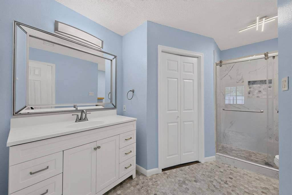 6747 Silver Sage Drive, Fort Worth, TX 76137 White vanity with a solid surface countertop and undermount sink