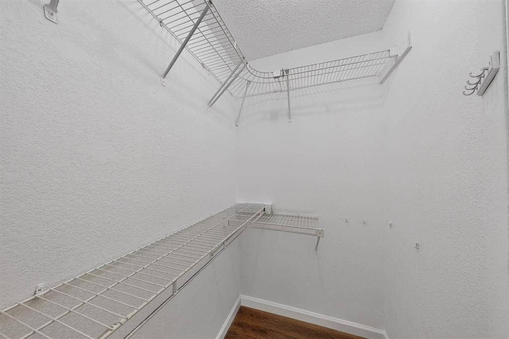 6747 Silver Sage Drive, Fort Worth, TX 76137 Built-in wire shelving, integrated wall hooks, and wood-finish flooring